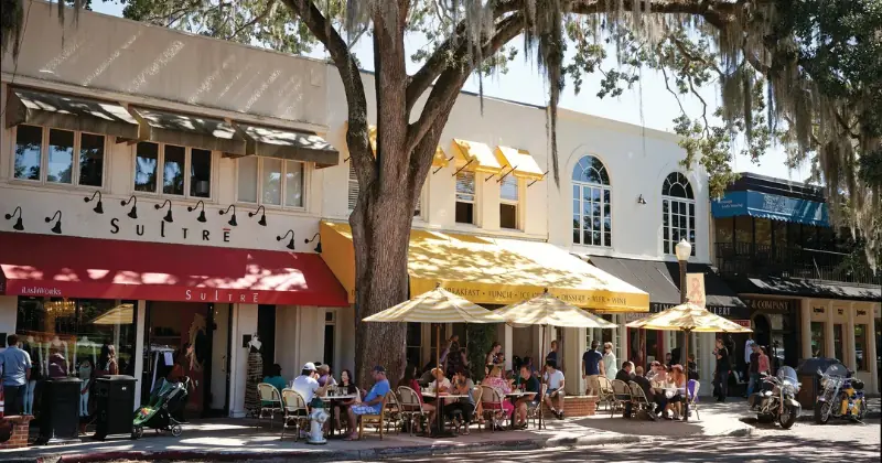 Street view of downtown Winter Park, Florida, featuring its charming shops, restaurants, and bustling sidewalks.
